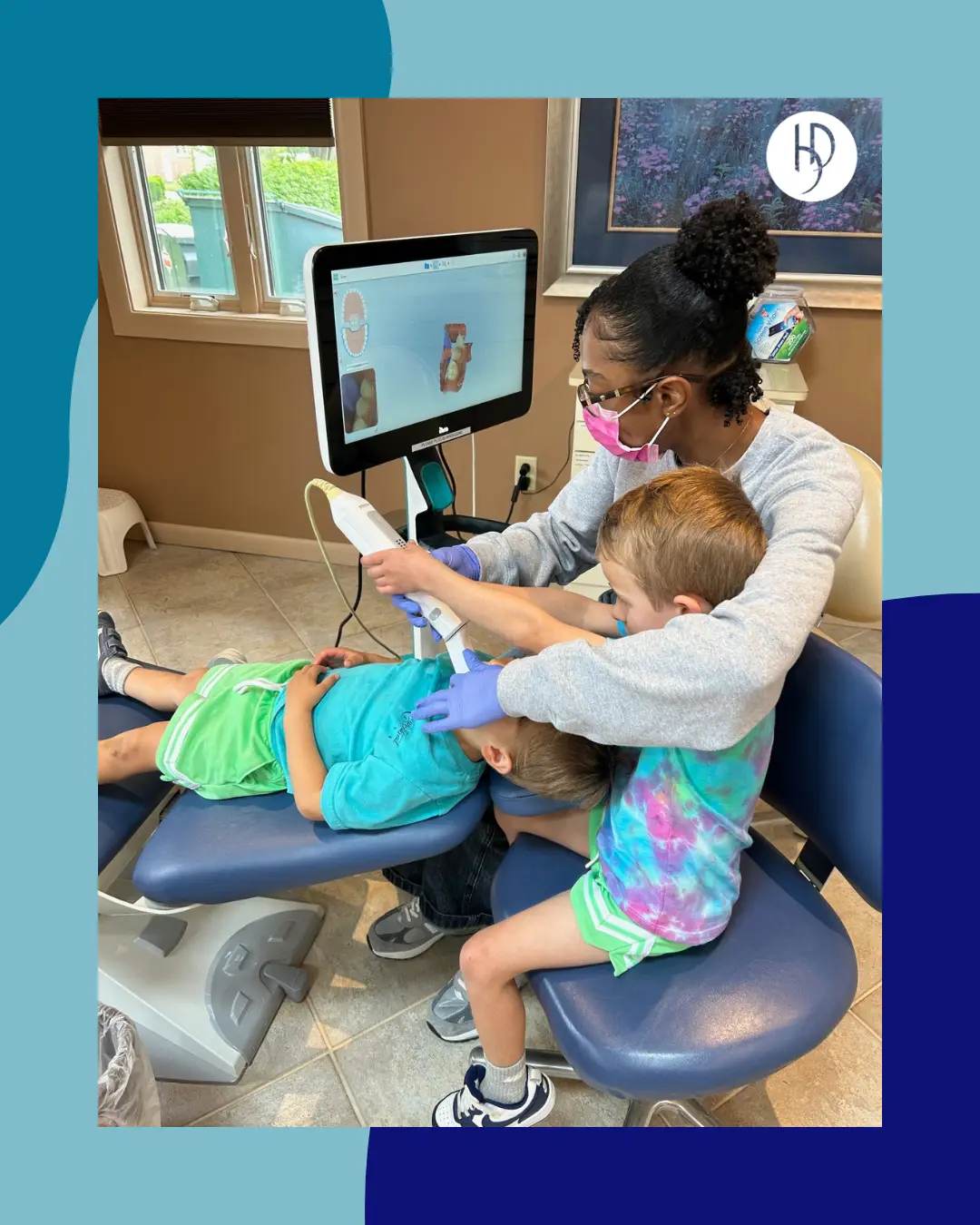Orthodontic assistant showing a child how to use a digital intraoral scanner